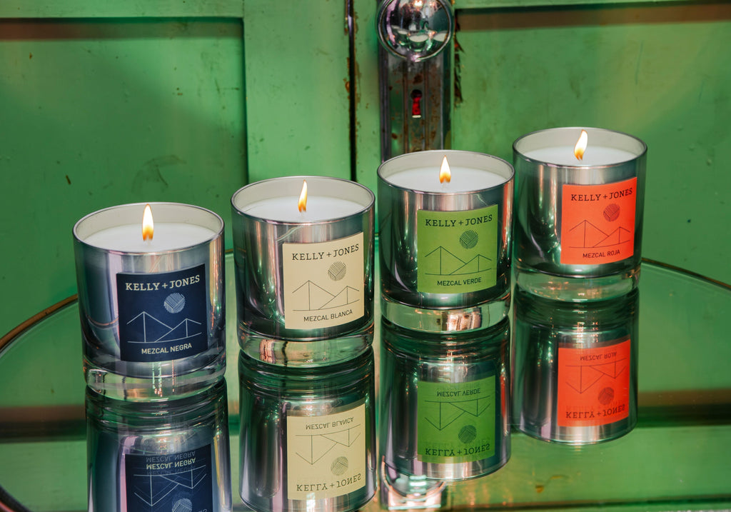 The K+J eau de mezcal candle collection on a hand-made table in Oaxaca with bright colors