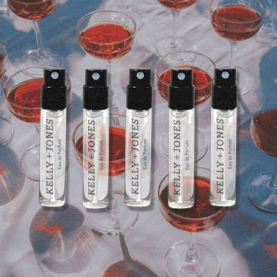 K+J Mezcal Blends Notes of Wine Sample Flight, 3 vials against surreal blue background with red wine in wine glasses pattern