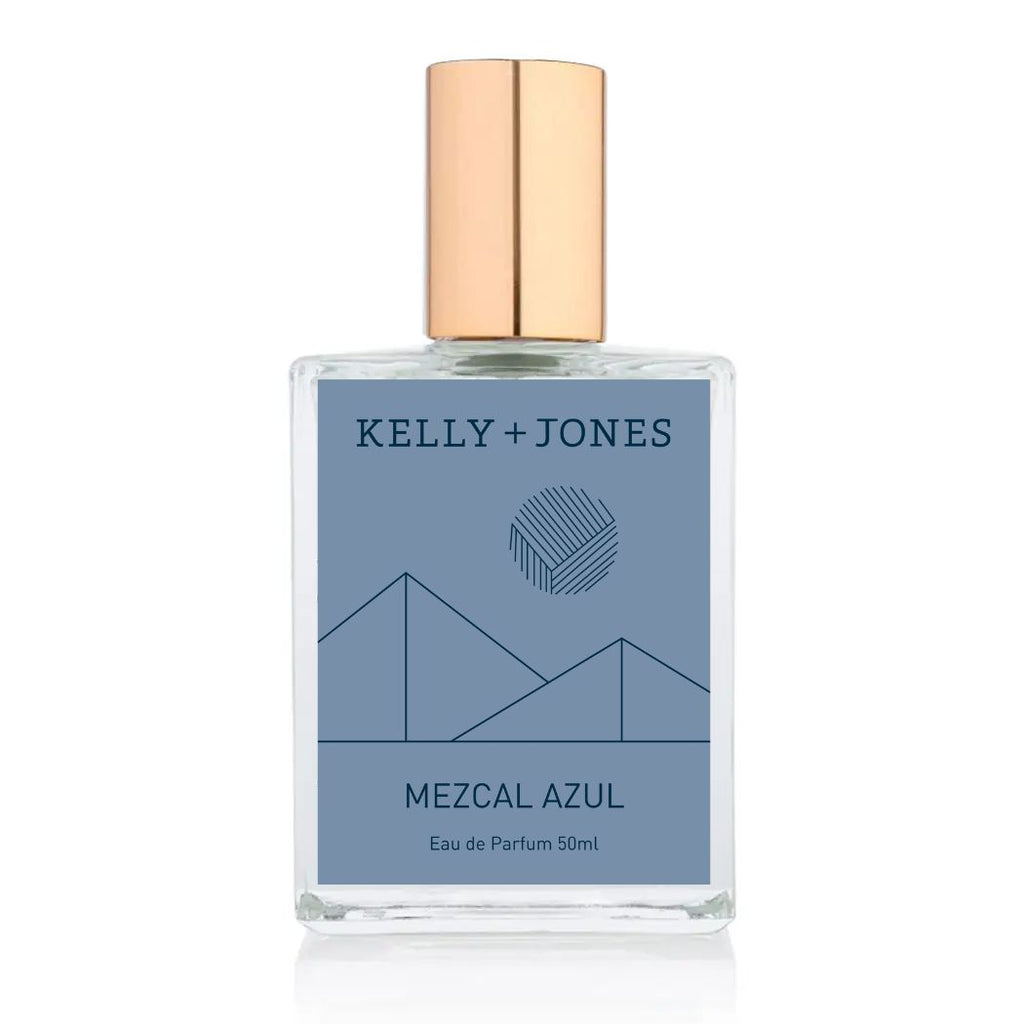 A bottle of Kelly + Jones Mezcal Azul Eau de Parfum Spray with a blue label and a gold cap.