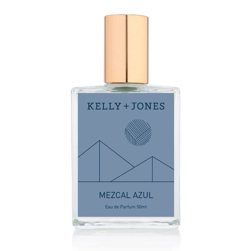 A bottle of Kelly + Jones Mezcal Azul Eau de Parfum Spray with a blue label and a gold cap.
