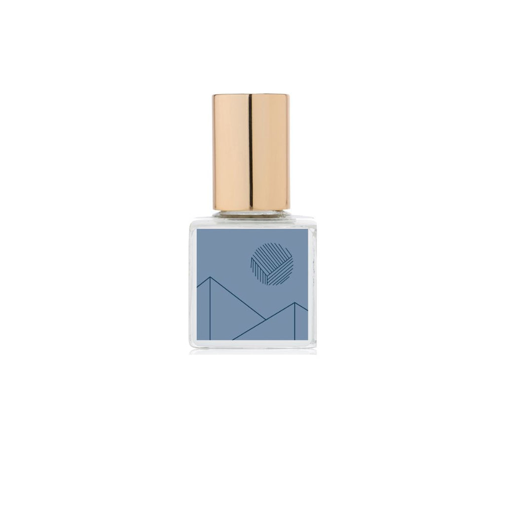 A bottle of Kelly + Jones Mezcal Azul Eau de Parfum Spray with a blue label and a gold cap.