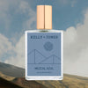 Kelly + Jones Mezcal Azul fragrance bottle on agave field backdrop
