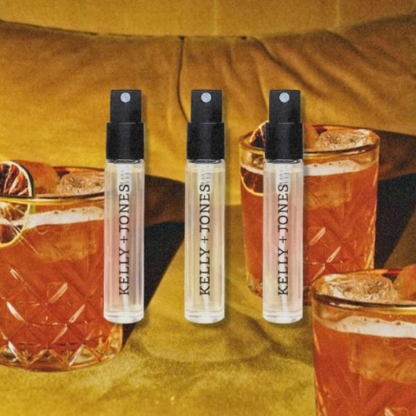 K+J Mezcal Gold Sample Flight, 3 vials against a retro-orange background with cocktails and orange velvet